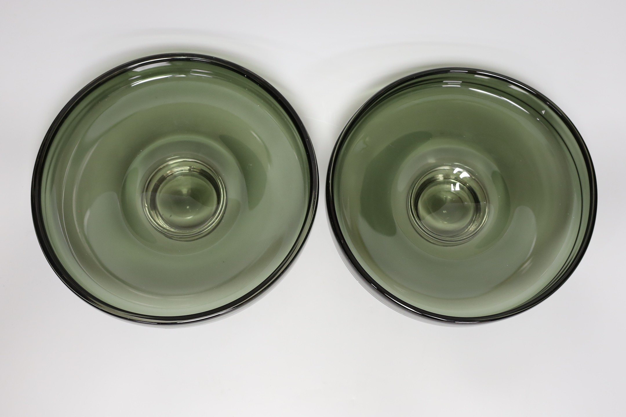 A pair of Scandinavian green glass dishes, 26cms diameter